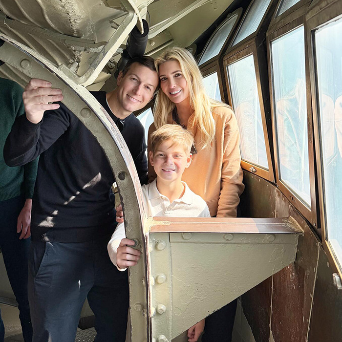 Family smiling inside a vintage aircraft cabin, sparking Ivanka Trump concerns.