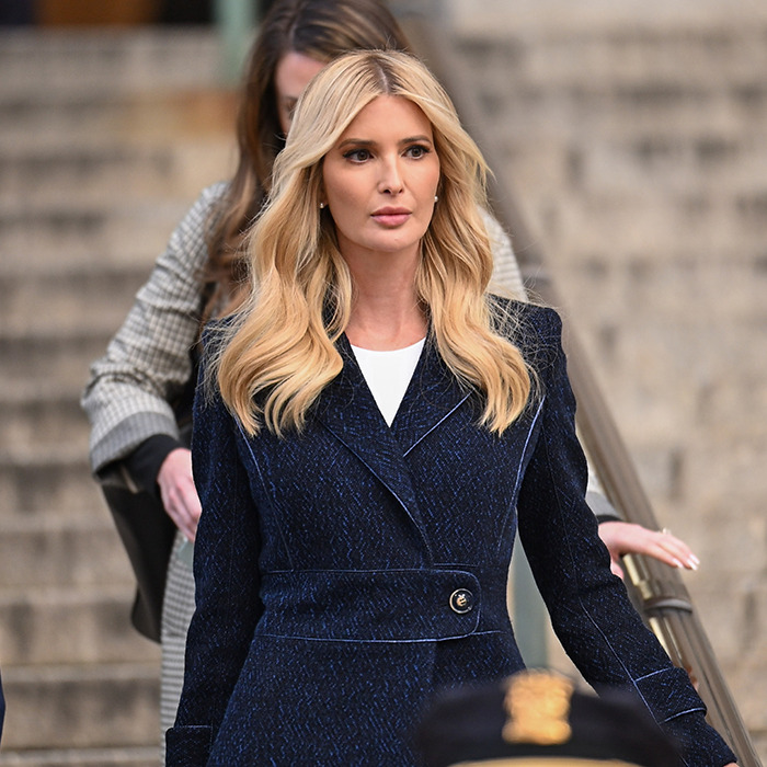 Blonde woman in a navy coat walking down stairs, causing concerns with a recent photo.