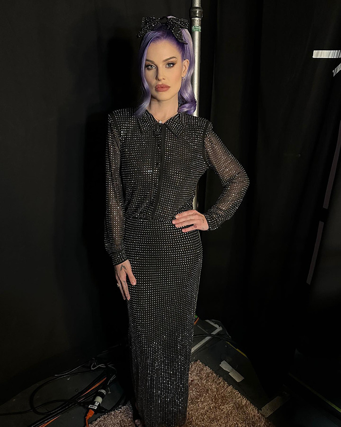 Person in black sparkling outfit and purple hair, showcasing dramatic weight loss amidst Ozempic rumors.