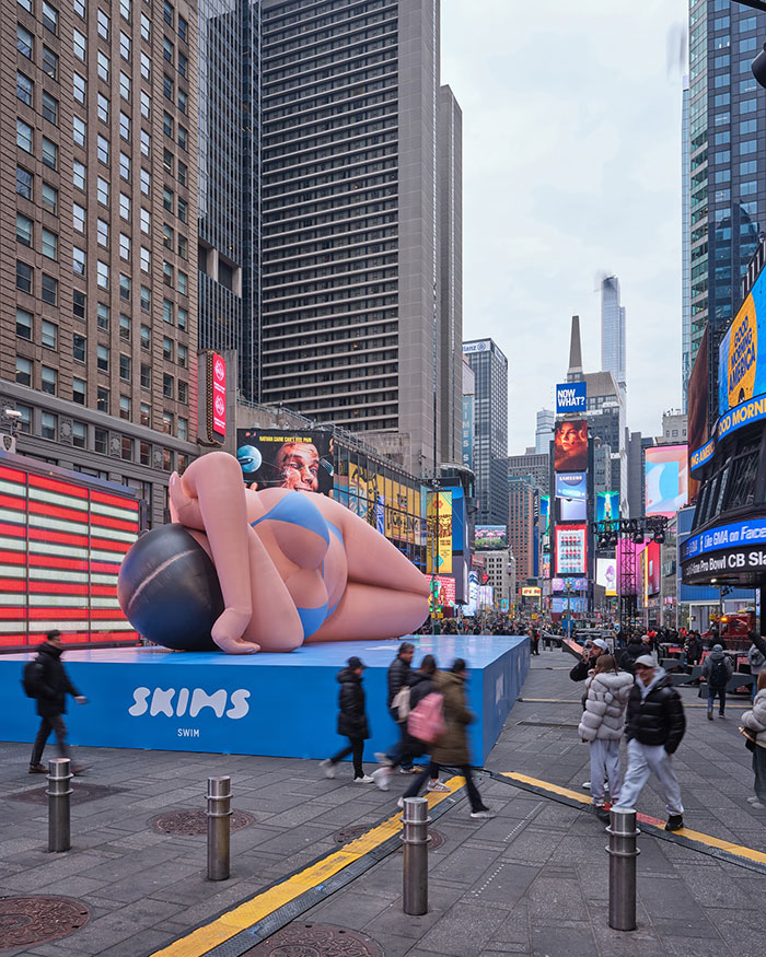 Giant bikini blow-up doll in Times Square attracting attention and generating backlash.