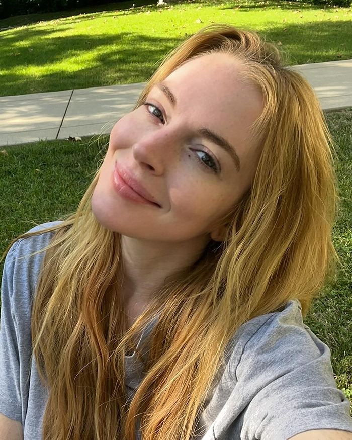 Lindsay Lohan smiling for a selfie outdoors.