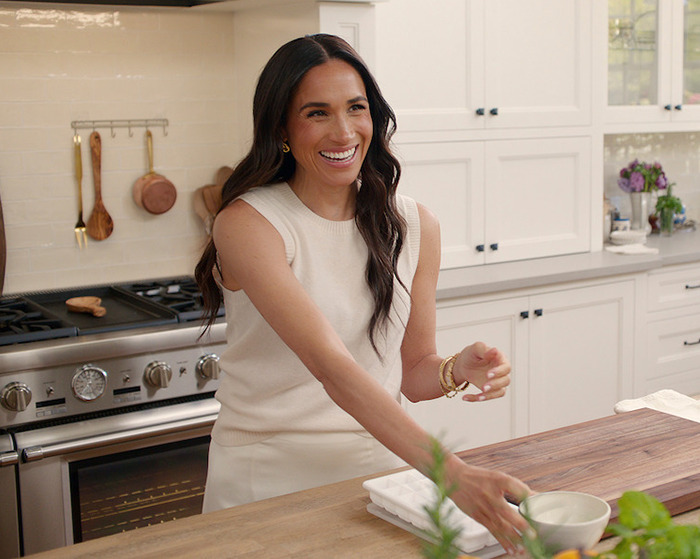 A woman smiling in a kitchen, sparking multiple controversies related to her show.