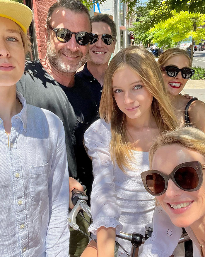 Group photo outdoors with six people, including Naomi Watts' daughter Kai, capturing a joyful moment in the sun.