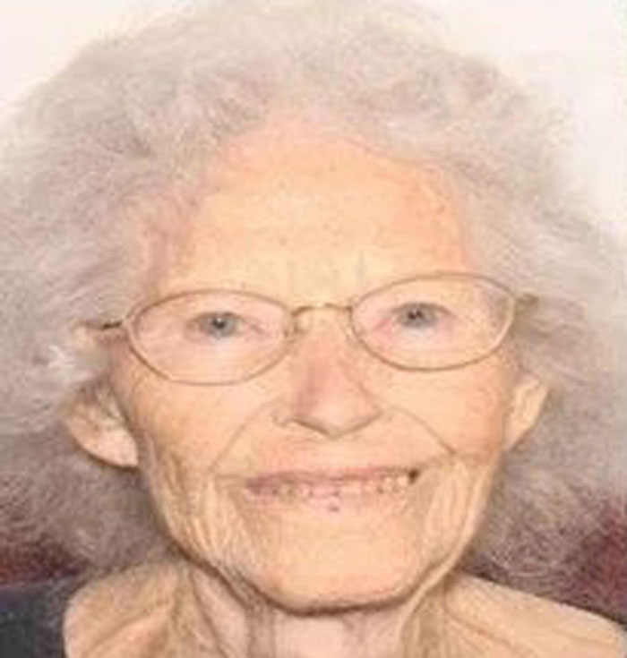 An elderly woman with glasses smiles softly; related to a disappearance case.