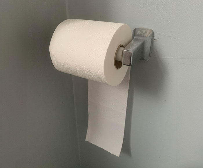 Toilet paper roll flipped incorrectly on holder, highlighting controlling tendencies issues.