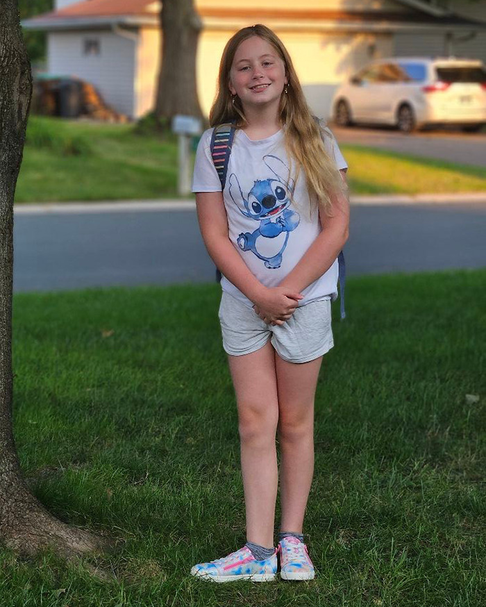 Young girl standing on grass wearing a Stitch shirt, related to lenient prosecutor case.