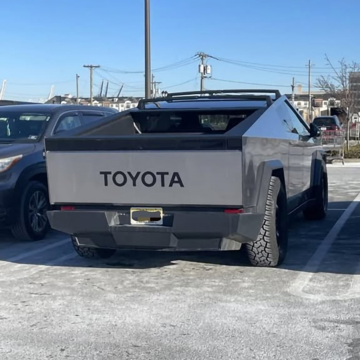 Tesla altered to display Toyota logo in parking lot, reflecting Elon Musk controversy concerns.