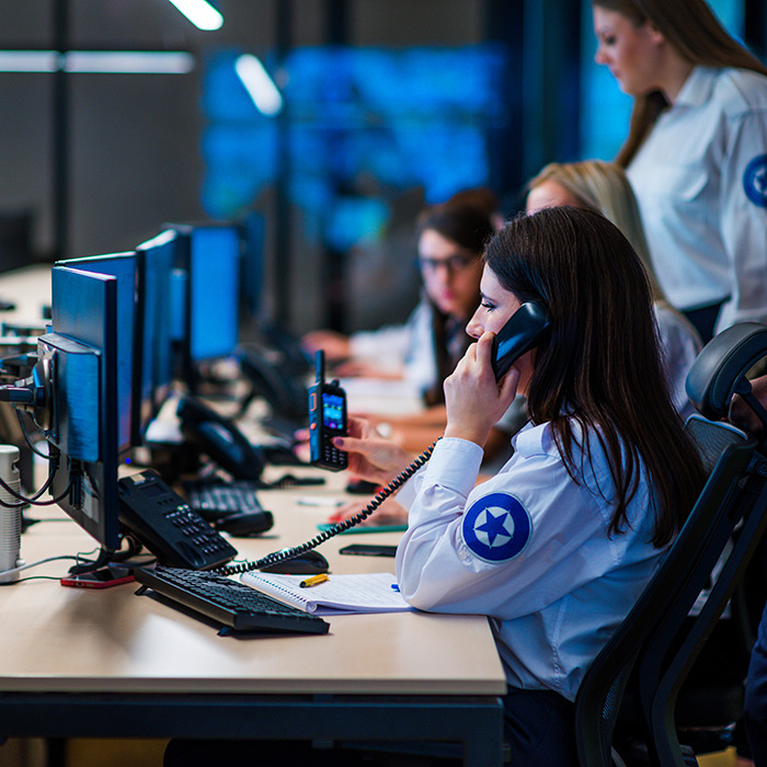 Team at work in an emergency call center, monitoring screens and taking calls, related to a girl found after 26 years.