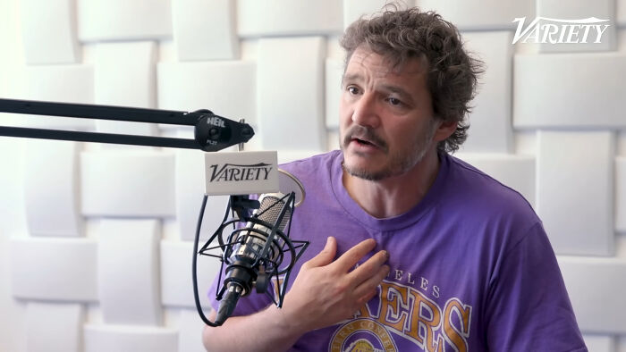 Man in a Lakers shirt speaks into a microphone for Variety, discussing petty reasons people hold grudges against celebrities.