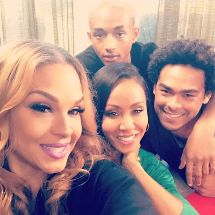 Group selfie with friends smiling indoors.